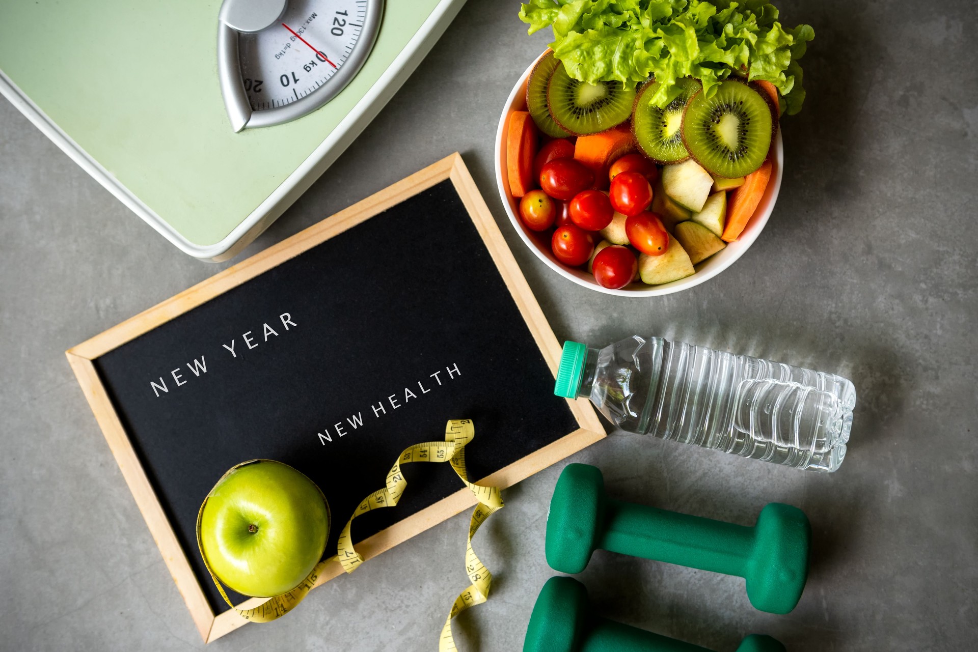 New Year for New Healthy 2021.  Fresh vegetable salad and healthy food for sport equipment for women diet slimming weight loss background.