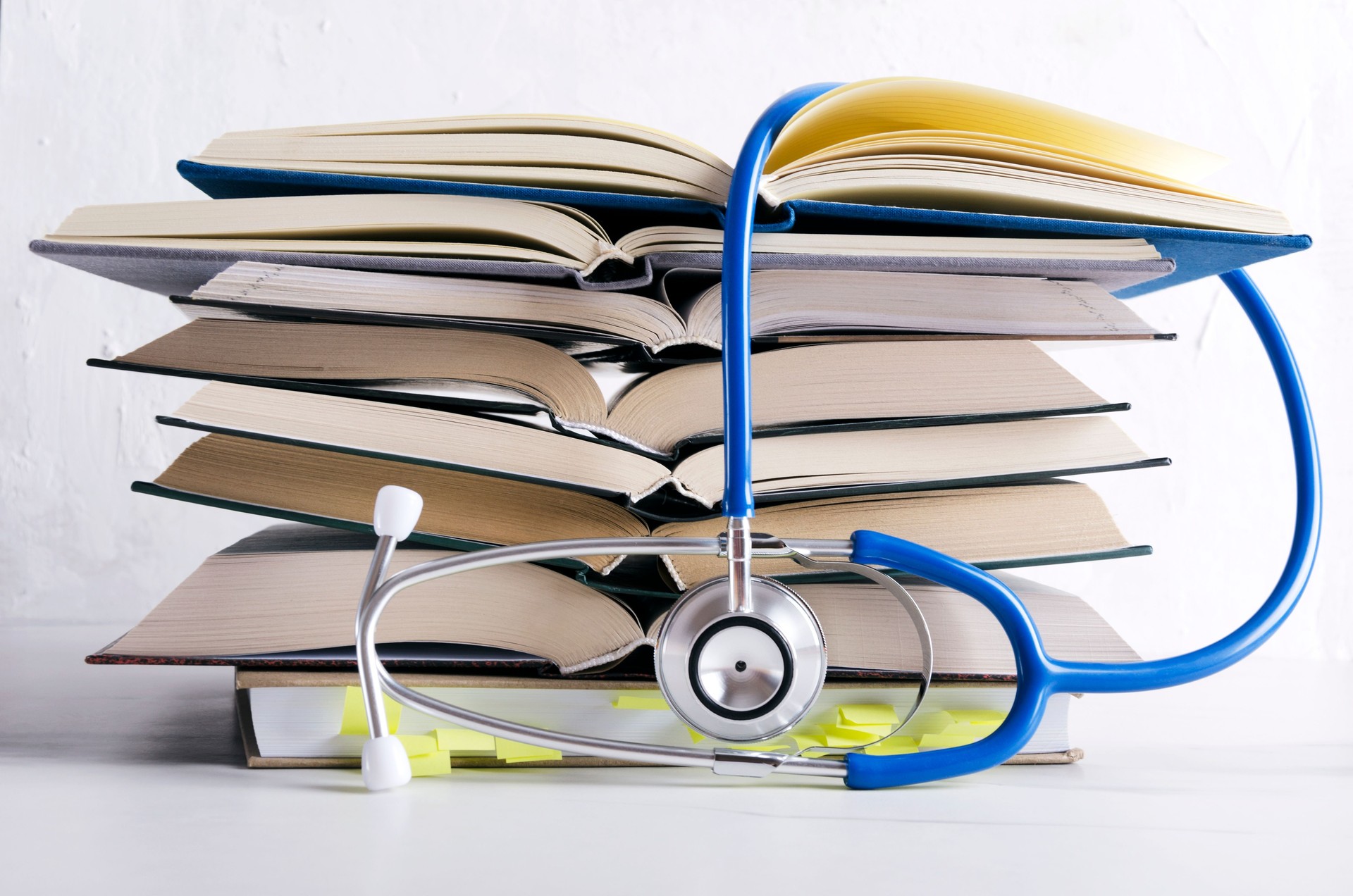 Medical knowledge. Pile of open books for medical student