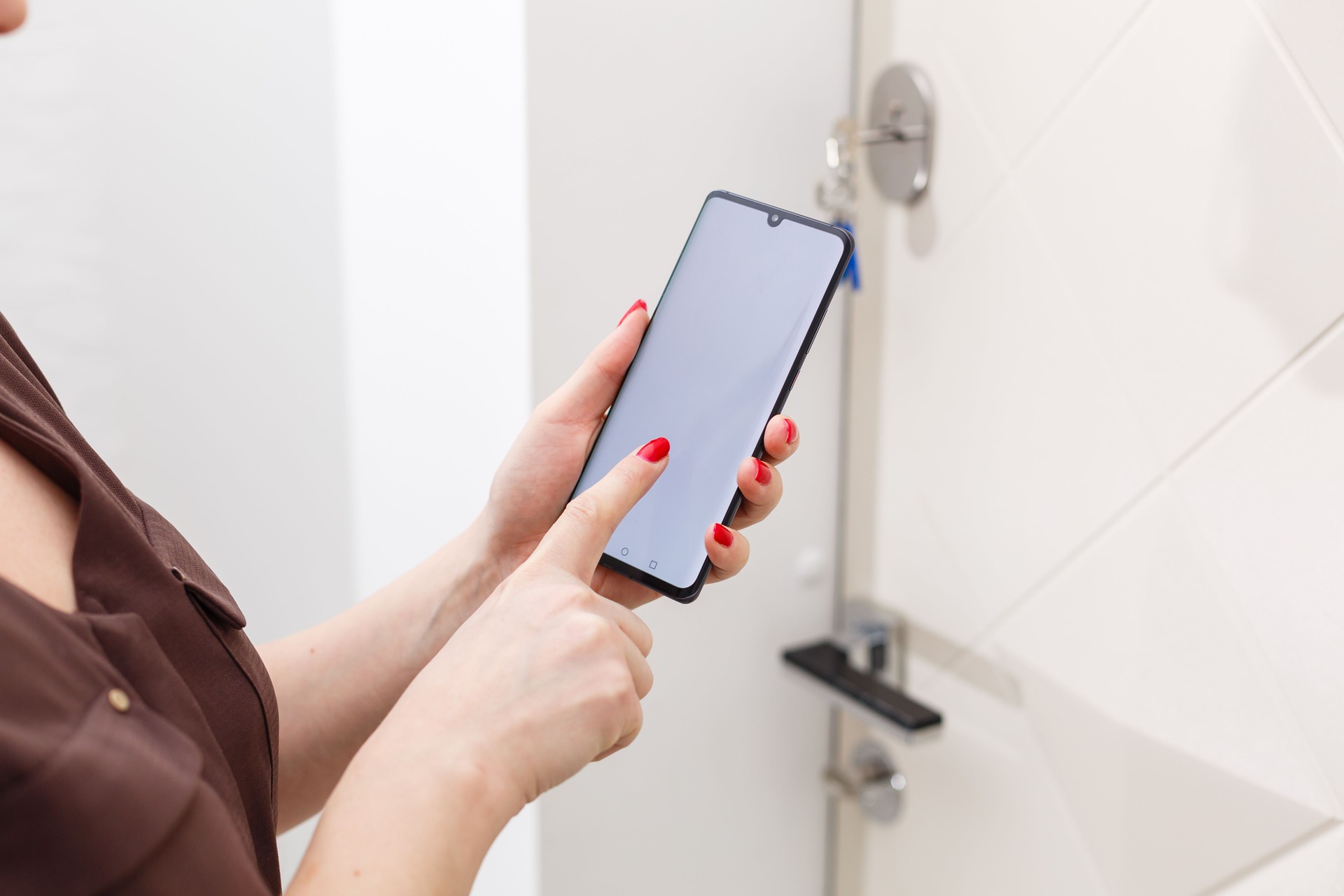smart house, home automation, device with app icons. Woman uses smartphone with smarthome security app to unlock the door of house.